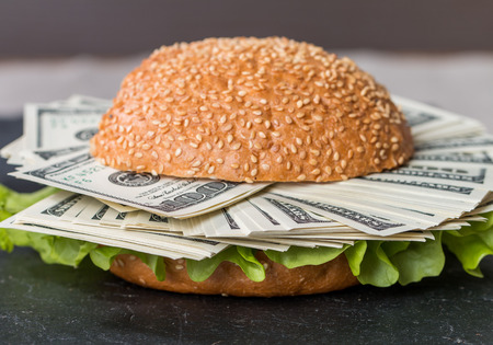 Hamburger with dollar bank notes on black backgroundの写真素材