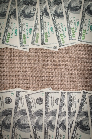 Frame from the dollars on burlap backgroundの写真素材