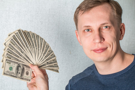 Business Man Displaying a Spread of dollars Cashの写真素材