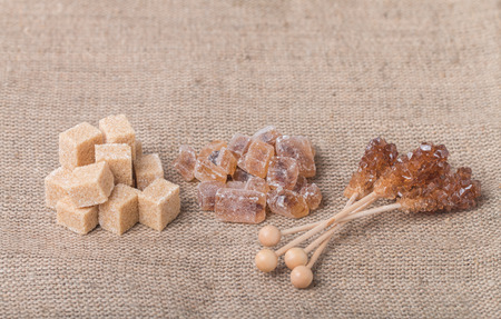 Various kinds of brown sugar on  burlap backgroundの写真素材