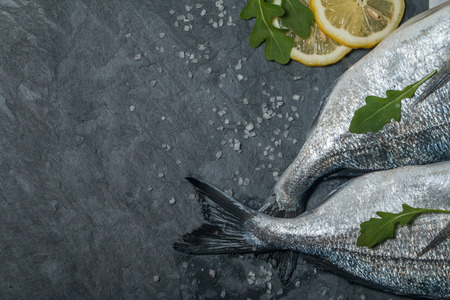 Delicious fresh  dorado on dark vintage background top viewの写真素材