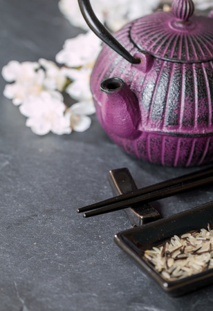 Chinese  Set, teapot, chopsticks and sakura branch on black backgroundの写真素材