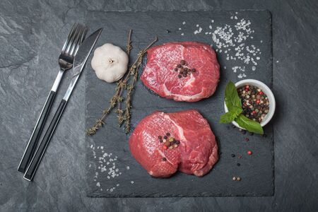 Raw fresh marbled meat Steak and seasonings on dark background top viewの写真素材
