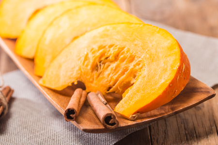 Slices of fresh pumpkin on wooden background, selective focusの写真素材