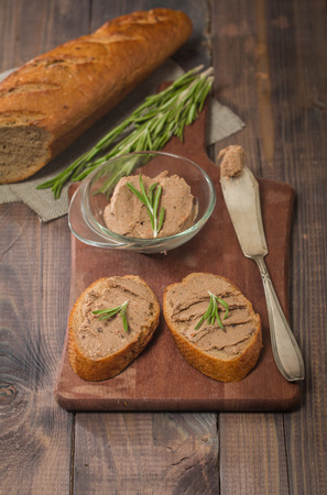 Homemade meat snack  liver pate with toast on rustic backgroundの写真素材