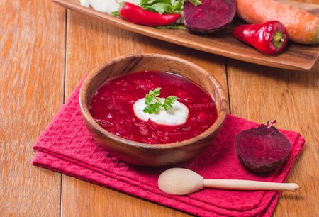 Soup with red beets in wooden bowl. Russian traditional dish. Borschの写真素材