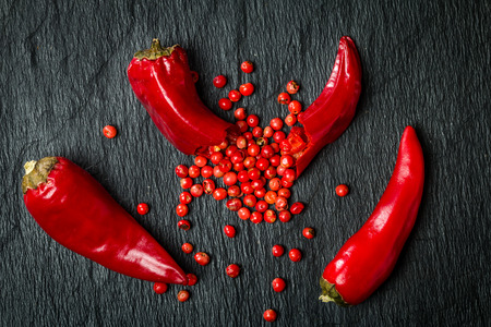 Chili pepper with red bell pepper inside on a black backgroundの写真素材