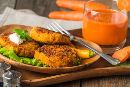 Healthy vegetarian carrots cutlets on  wooden backgroundの写真素材