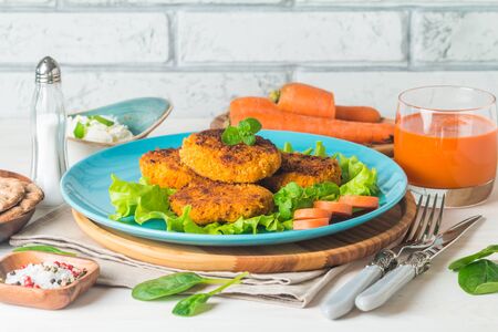 Healthy vegetarian carrots cutlets on white wooden backgroundの写真素材