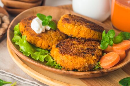 Healthy vegetarian carrots cutlets on white wooden backgroundの写真素材