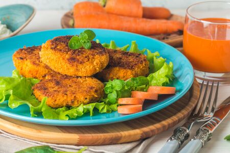 Healthy vegetarian carrots cutlets on white wooden backgroundの写真素材