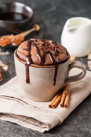 Chocolate souffle with  chocolate glaze in a cup on grey backgroundの写真素材
