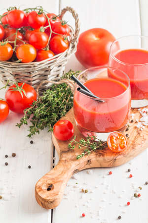 Tomato Juice and Fresh Tomatoes  on a White Wooden Backgroundの写真素材
