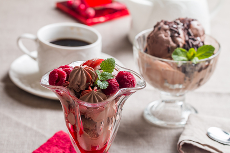 chocolate ice cream with raspberry sauce in a glass cupの写真素材