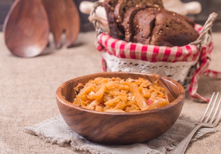 Cabbage stewed  in portions wooden plate on rustic background
