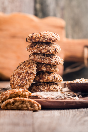 Oatmeal cookies on burlap and rustic wooden tableの写真素材