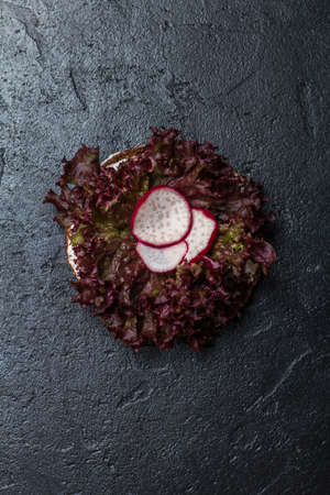 Vegetarian sandwich with cream cheese and lettuce on black background, top viewの写真素材