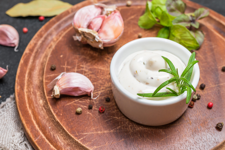 Bowl of Mayonnaise sauce on  wooden cutting boardの写真素材