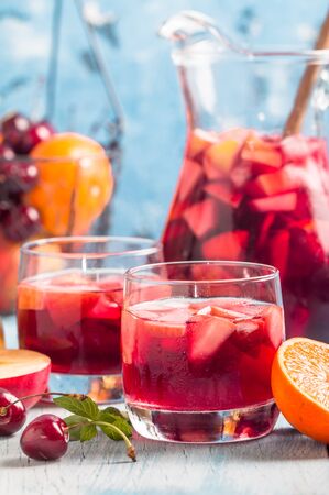 Refreshing sangria or punch with fruits in glasses and pincherの写真素材