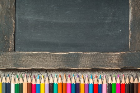 back to school frame of multicolored pensils and chalk board, top view, copy spaceの写真素材
