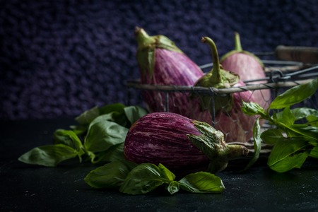 Fresh healthy eggplants on dark background close upの写真素材