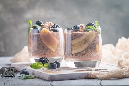 Vegan dessert, chocolate chia pudding with banana, berries and mintの写真素材