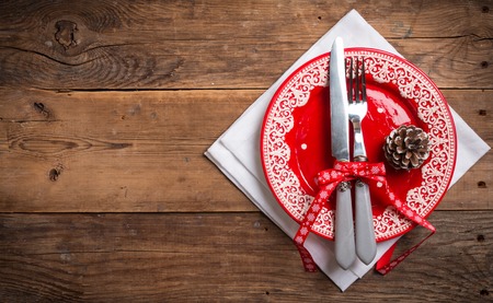 Christmas empty plate and silverware on wooden background as design element for menu, top view with copy spaceの写真素材