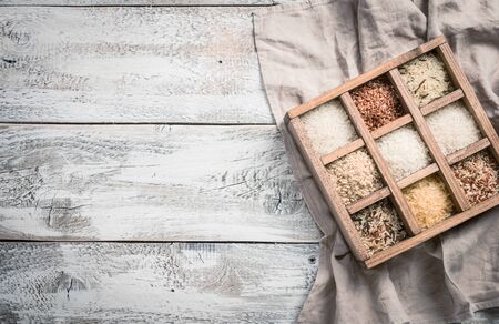 Varieties of rice in printers box, jasmine wild white pearl forbidden jade basmati and barley. Top viewの写真素材