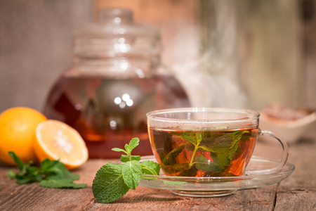 Glass cups of tea with mint on wooden tableの写真素材