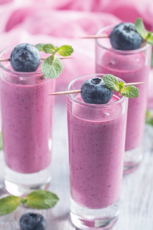 Delicious blueberry smoothie  with mint and fresh berries in glassesの写真素材