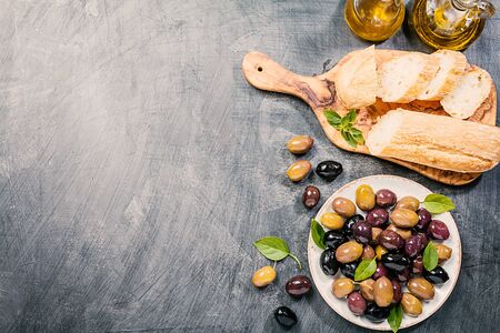 Olive oil, different olive fruites and fresh bread.の写真素材