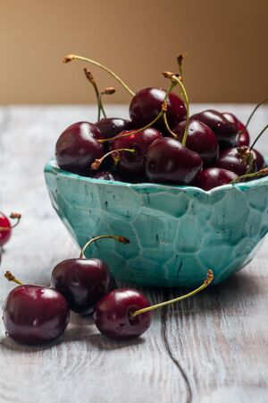 Cherries in a bowl with water dropsの写真素材