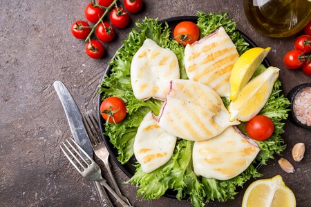 Grilled squid with lemon and vegetablesの写真素材