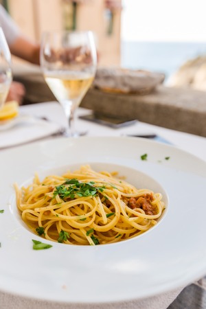 italian pasta spaghetti with sea urchin on a white plate in a rastauranteの写真素材