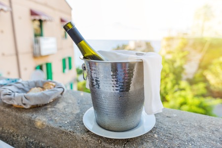 a bottle of wine in an ice bucket in the open area of restauranteの写真素材