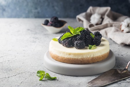New York cheesecake or classic cheesecake with fresh berries on gray stone backgroundの写真素材