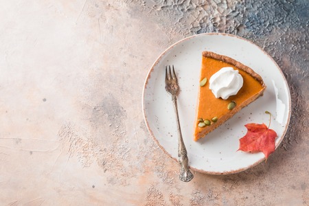 Slice of Festive Homemade Pumpkin Pie with Whipped Cream, top viewの写真素材