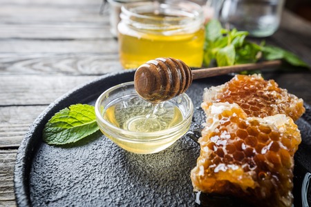 Honey with wooden honey dipperの写真素材