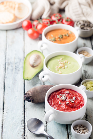 Variety of different colorful vegetable cream soups in a bowls. Concept of healthy eating or vegetarian food.の写真素材