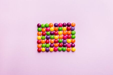 Colorful Candy bonbon snack set. Sweet pink background. Top view, flat lay