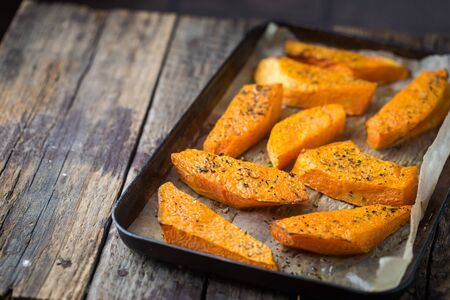 Baked pumpkin slices with honey, oil and herbsの写真素材
