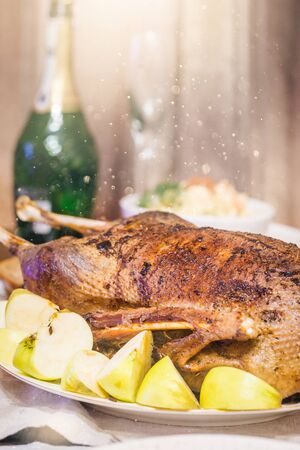 Christmas roast duck with apples served on a festive tableの写真素材