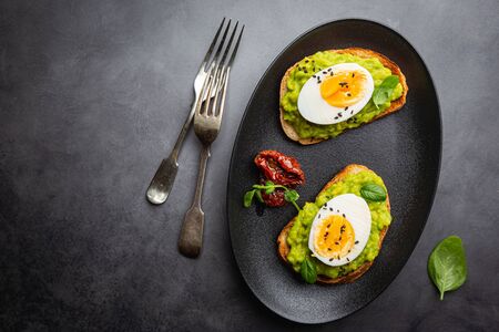 Healthy breakfast, toast with avocado and egg, top view, copy space. Vegetarian food conceptの写真素材