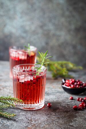 Fresh cranberry cocktail with rosemary in a glass on gray background.の写真素材