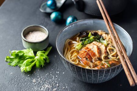 japanese soup with fried eel Yanagawa Nabe in a bowl on dark backgroundの写真素材