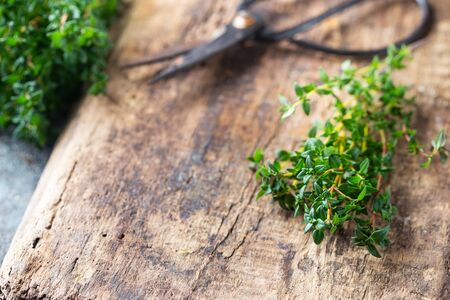Bunch of fresh thyme herb on old wooden boardの写真素材