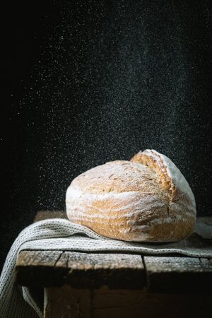 Fresh homemade crisp bread on wooden background. French bread. Bread at leaven. Unleavened breadの写真素材