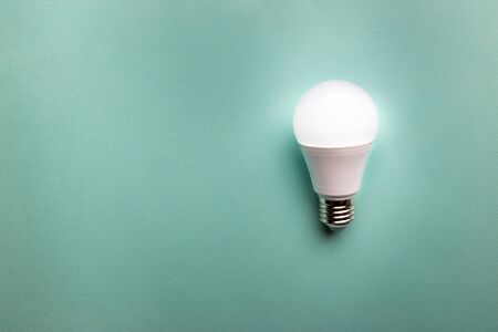 Creativity inspiration, ideas concepts with light bulb on blue color background.Flat lay design.の写真素材