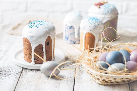 Easter table with Easter cakes and Easter eggs over white background