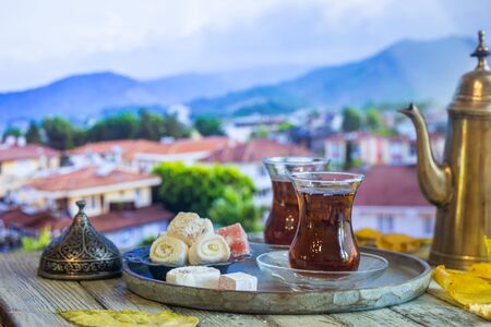 Glass Cup of turkish tea served in traditional style with summer outdore viewの写真素材
